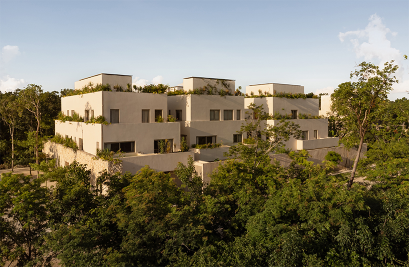 stacked chukum & stone volumes wrapped in green terraces shape RA!'s residences in tulum