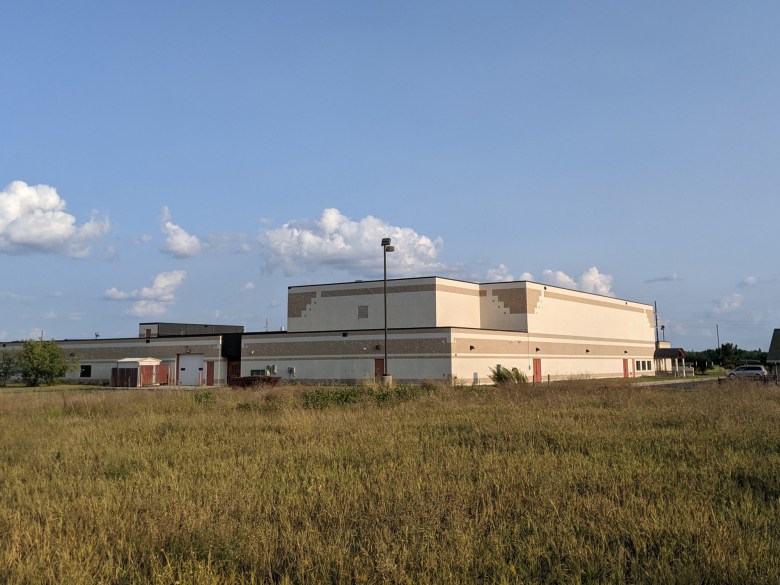 A beige school building with brown stripes evoking Native American decor.