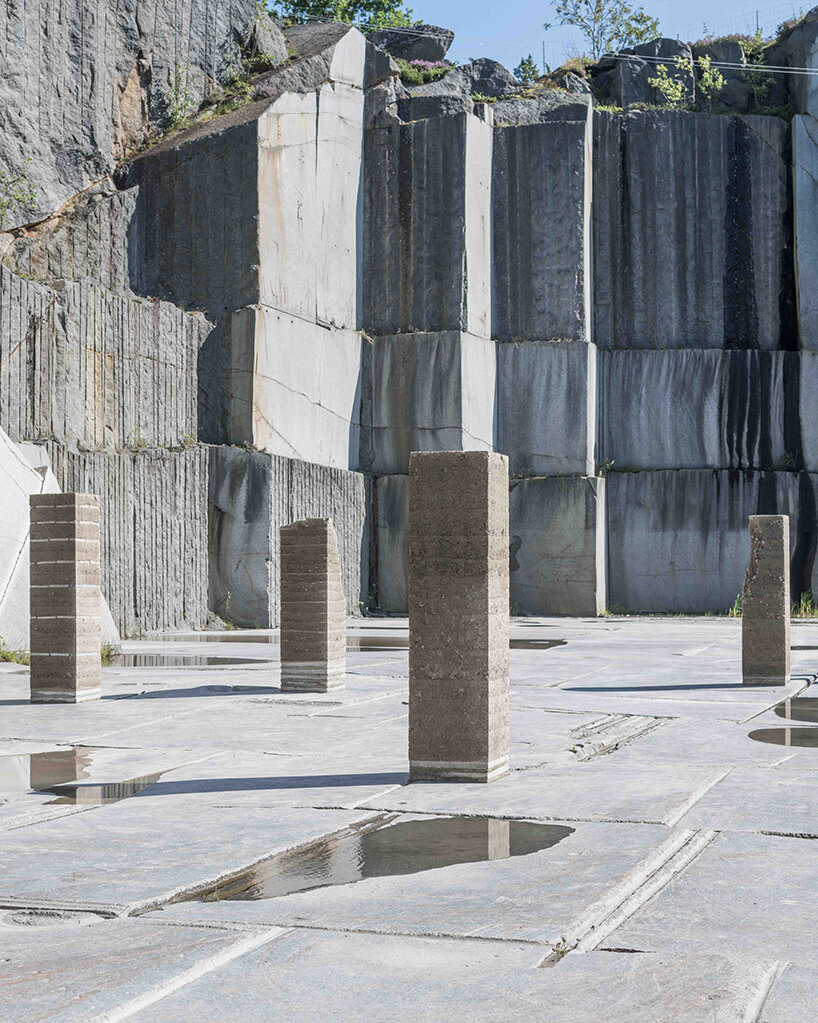 natural forces sculpt rammed earth columns in sustainable norwegian quarry installation