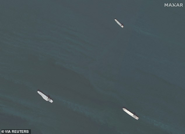 The carrier (bottom left) was pictured in formation with two of Iran's naval ships: Shahid Roudaki (top right) and Shahid Mahdavi (bottom right)