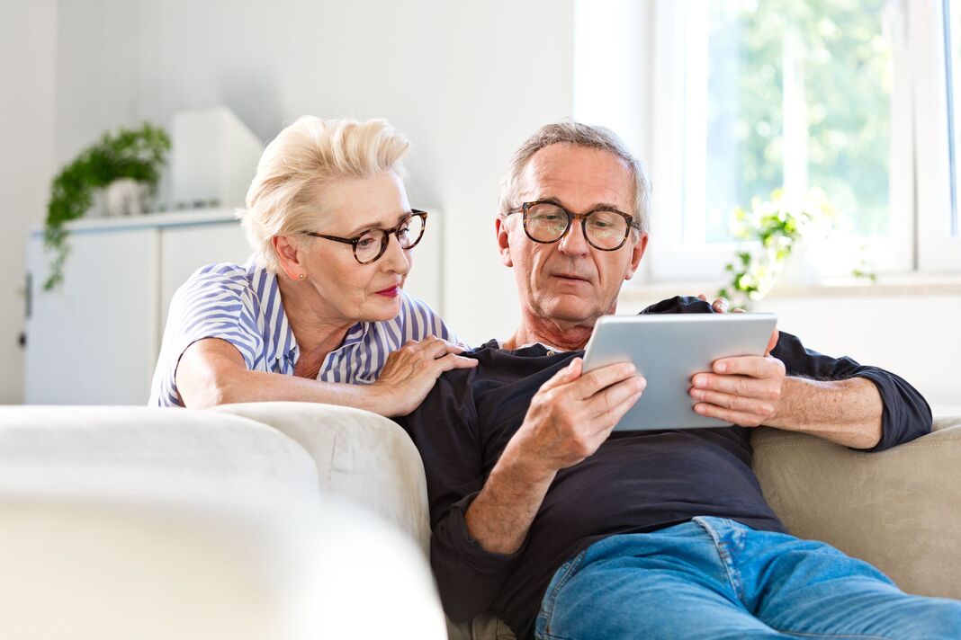 Senior couple looking at finances on a tablet