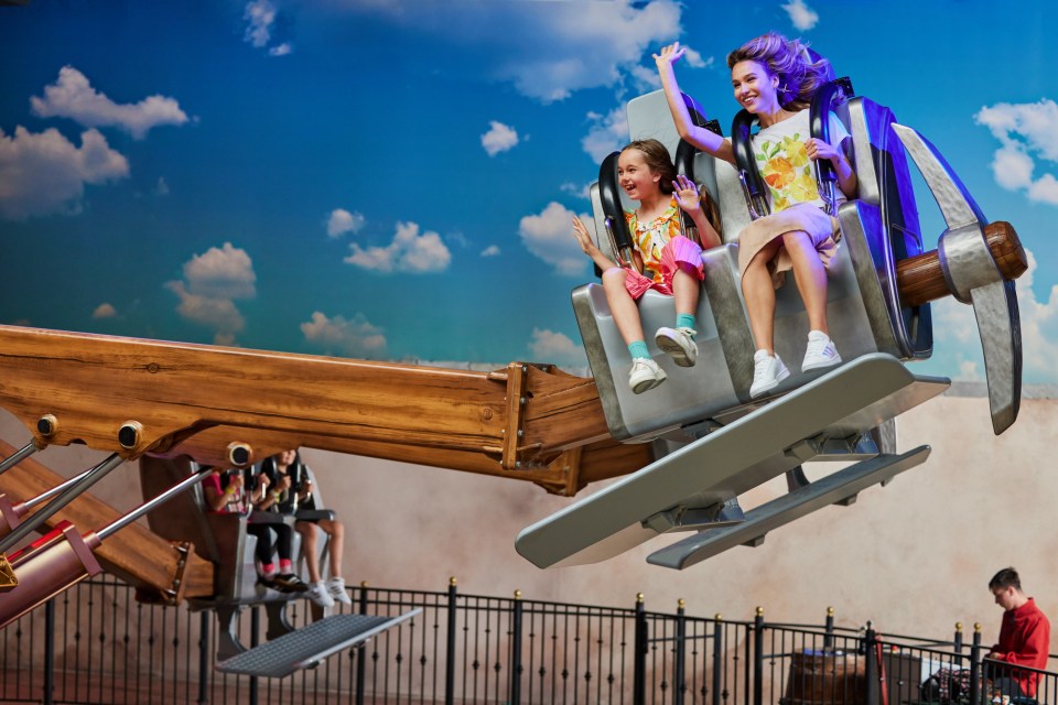 Woman and child enjoying a ride at Mandoria Polish Indoor Theme Park.