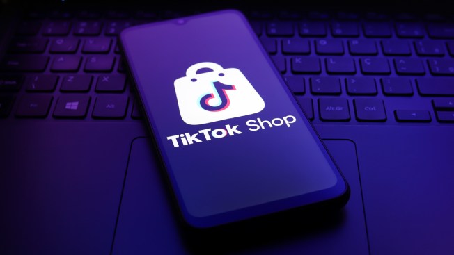 The TikTok Shop logo appears on the screen of a smartphone.