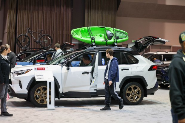 Visitors look at a Toyota RAV4 Hybrid on display during the 2025 Silicon Valley Auto Show at the Santa Clara Convention Center in Santa Clara, Calif., on Friday, Feb. 21, 2025. Attendees explored the latest vehicles from 17 manufacturers, the chance for test drives, and a demo of a TOboR Home Dog. The show runs from Friday, Feb. 21, through Sunday, Feb. 23. (Ray Chavez/Bay Area News Group)