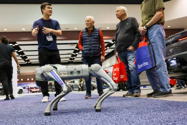 TOBoRLife sales and consumer specialist Corey DuVal, left, makes a demo of TOBoR Home Dog as visitors look on during the 2025 Silicon Valley Auto Show at the Santa Clara Convention Center in Santa Clara, Calif., Friday, Feb. 21, 2025. The two-passenger self-driving car is fully autonomous with no steering wheel or pedals. Attendees explored the latest vehicles from 17 manufacturers and the chance for test drives. The show runs from Friday, Feb. 21, through Sunday, Feb. 23. (Ray Chavez/Bay Area News Group)