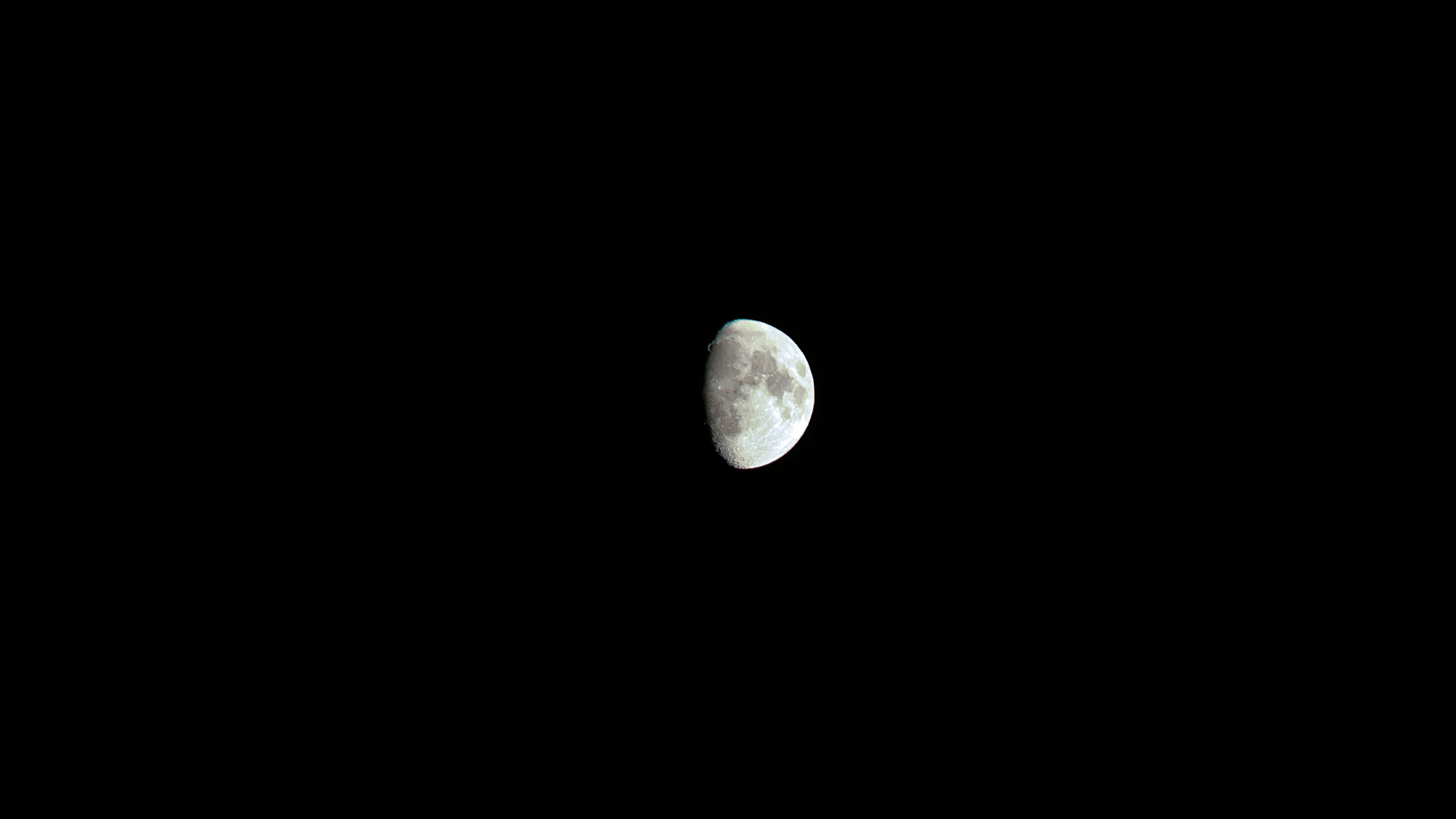 77% waxing gibbous moon against a dark sky