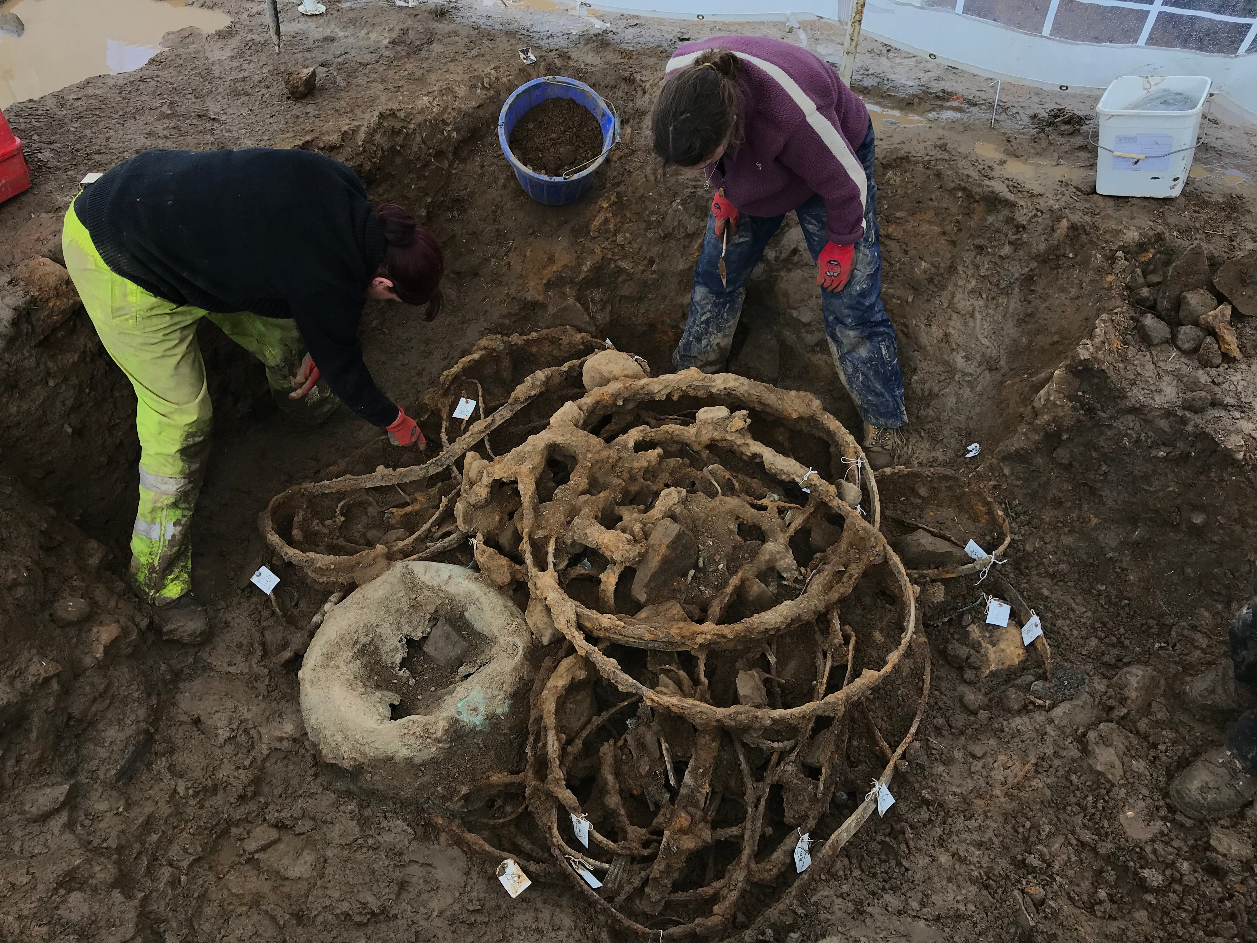 The bent iron tyres and cauldron at the excavation site