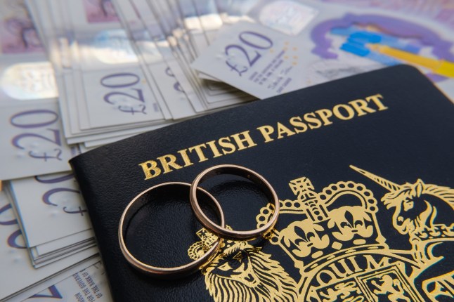A UK passport on a bed of money