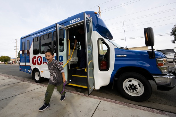 Justin Winchester, 7, uses the new GoMicro van service for...