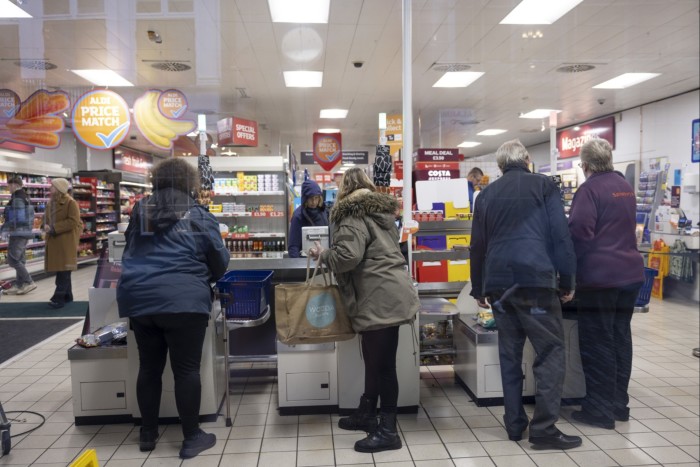 Shoppers use self-service checkouts in a J Sainsbury supermarket in Guildford, UK,