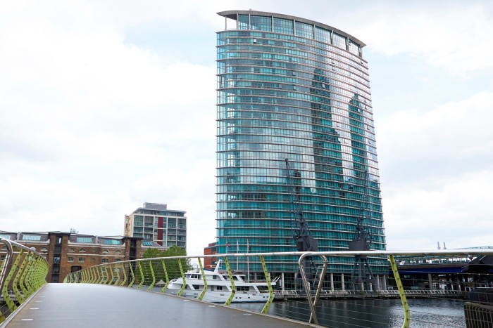 Empty bridge in London Docklands with One West India Quay in background