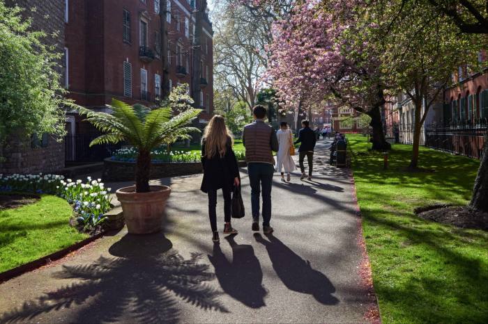 People walking through the Mount Street Gardens in Mayfair, London