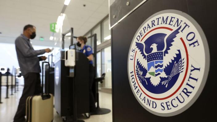 Staci Merten, a transportation security officer with the Transportation Security Administration, checks a passenger&#x002019;s identification at the TSA security checkpoint at Salt Lake City International Airport in Salt Lake City on Tuesday, May 18, 2021.