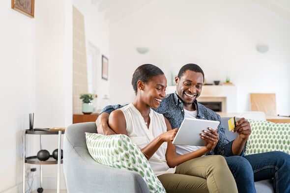 Couple smiling while assessing finances