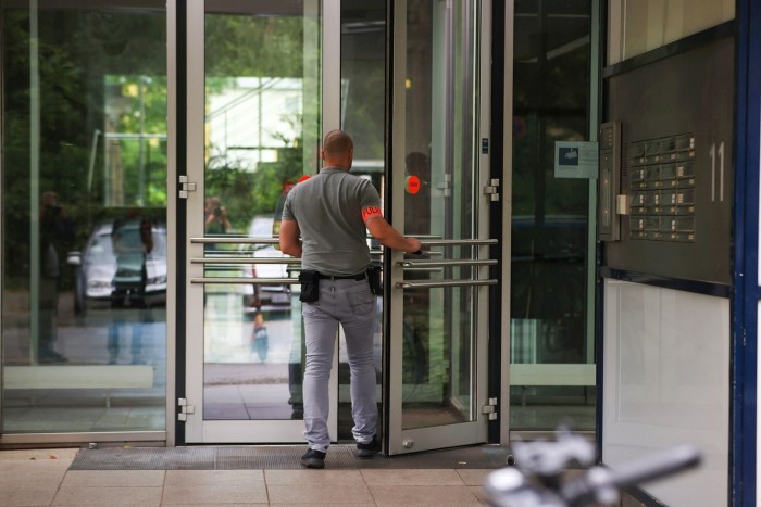 A police officer entering a building 