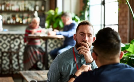 Man listening thoughtfully to business colleague in restaurant