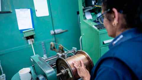 A worker operates a machine at the Brandauer manufacturing factory in Birmingham