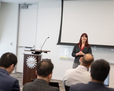 An NSF program director talks to Michigan Tech researchers during their Washington DC visit.