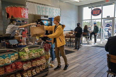 A worker picks up food from a restaurant for a Flytrex drone delivery in Holly Springs, North Carolina.