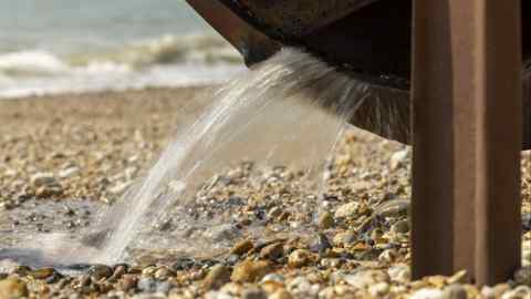 Waste water flows from an outflow pipe on Pagham Beach in Bognor Regis