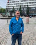 Douglas Jackson, pictured in Gothenburg standing in a cobbled square in front of a modern building and wearing a bright blue zip-up sporty jacket