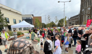 Crowds meet Zelva, the giant animatronic tortoise in Queen Elizabeth Gardens