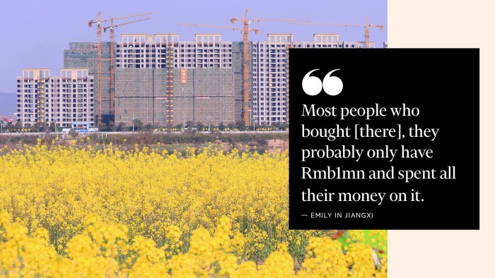 Rapeseed blossoms in a field with residential buildings under construction in the background in Taihe County, Jiangxi Province