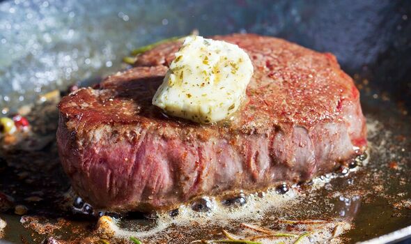 Steak cooking in a pan