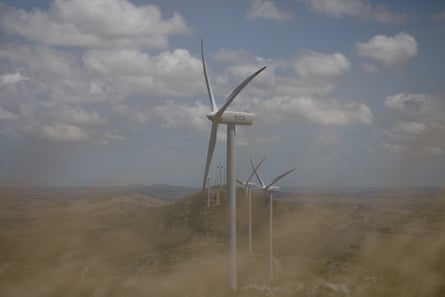 Shot of a long line of wind turbines stretching into the distance.