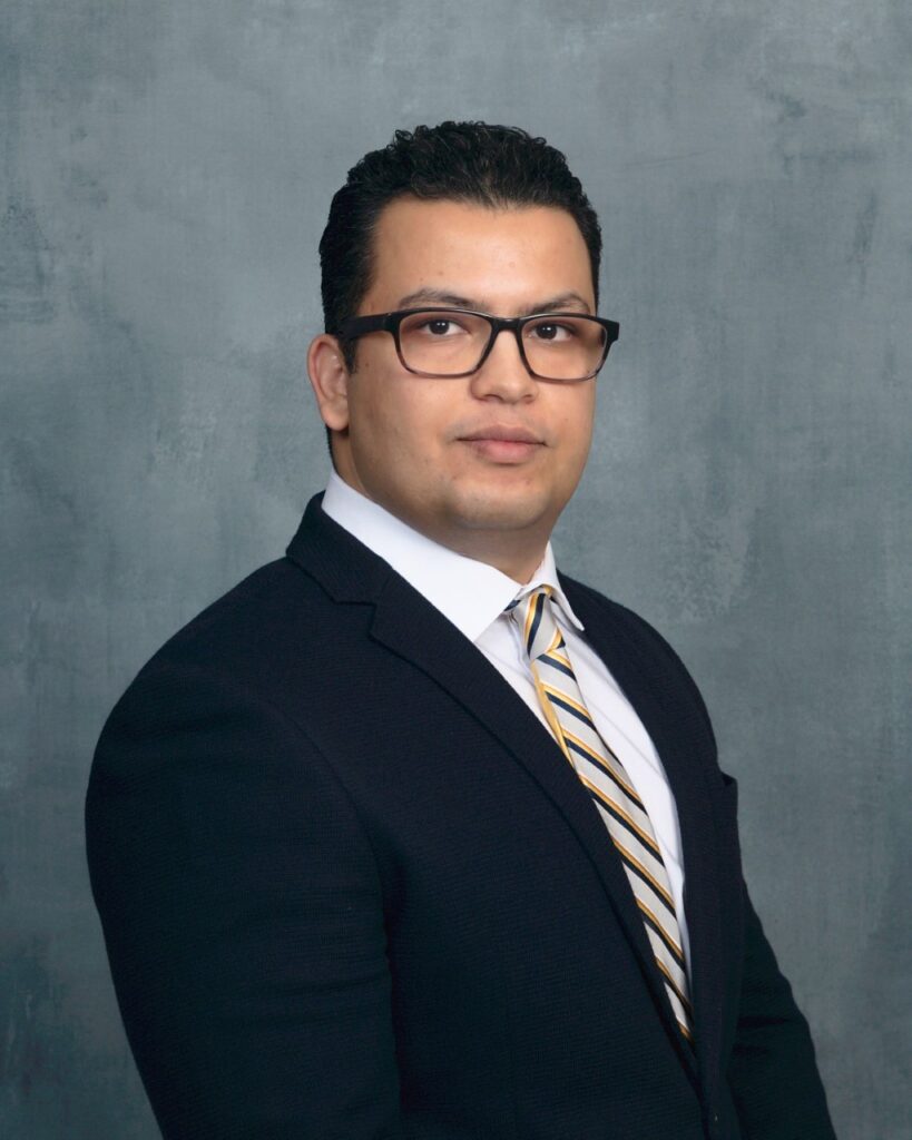 Head a shoulder photo of a man, Reza Ovissipour, Ph.D. He is wearing glasses, a dark jacket with a white shirt and a striped tie that has silver, black and gold.