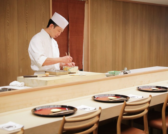 Chef Daisuke Hayashi of Roketsu at work behind the wooden counter