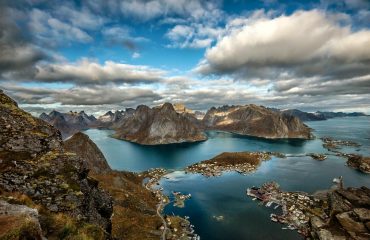 landscape photography of mountains surrounded by water