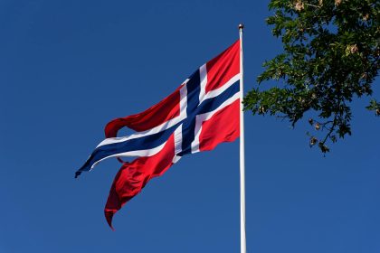 torn flag of norway billowing in the wind