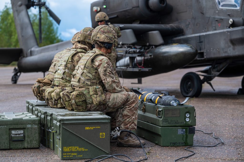 Armourers loading missiles onto an Apache attack helicopter. The SDR sets out plans to increase the UK's ammunition production, but it is not clear if it will include missile production for the Apache.