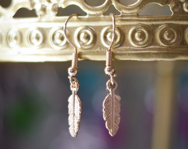 Golden metallic feather earrings.