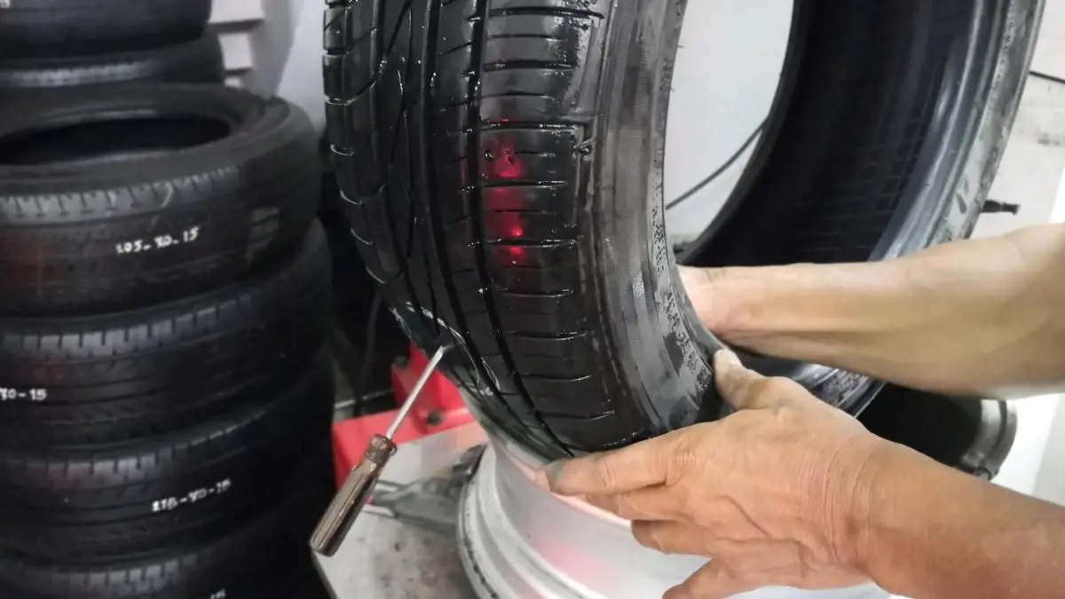 mechanic showing how to patch a tire