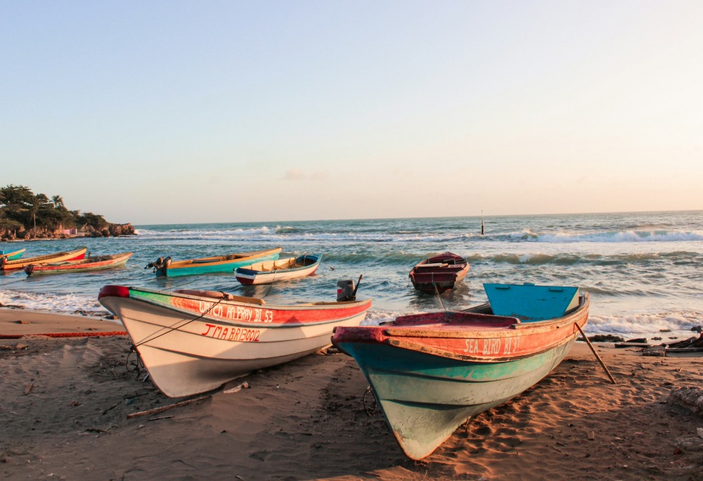Several boats ashore on a sandy beach in Jamaica