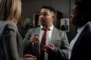 An attorney speaking to two women in his office