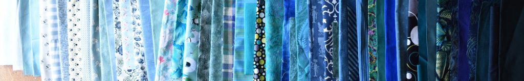 Blue-green fabrics arranged in order of value