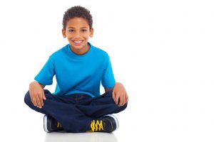 african american boy sitting on white background