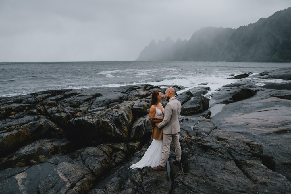 Keeping it real and focus on each other. Eloping in Senja, Norway during first autumn storm of the year. By Christin Eide Photography