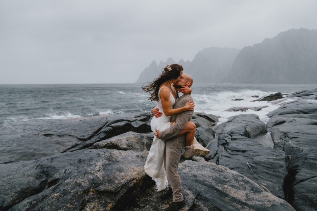 Bride and groom kissing during an elopement in Senja, Norway, photographed by Christin Eide Photography