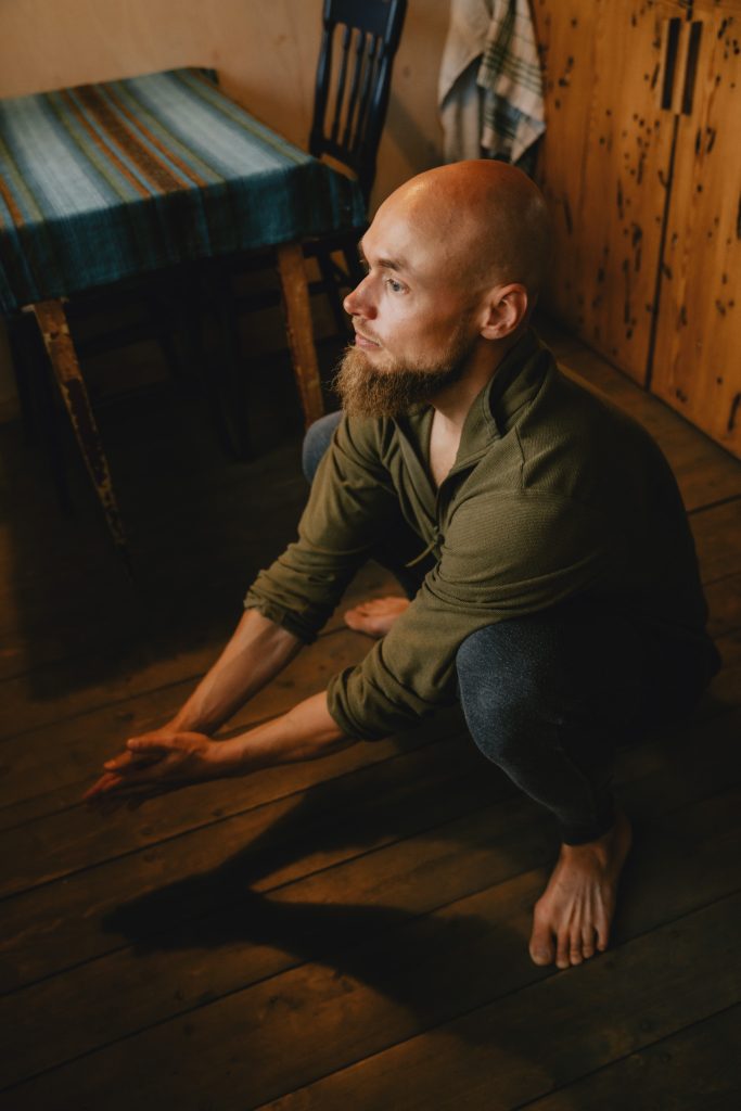 Moody Norway elopement on Senja Island. Relaxing with yoga before changing. By Christin Eide Photography.