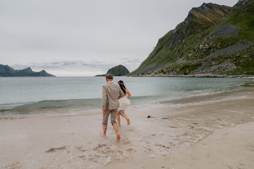 Newlyweds on the beach in Lofoten Norway. By Christin Eide Photography