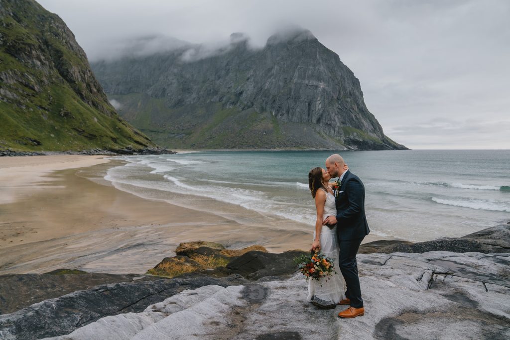First kiss on Kvalvika beach in Lofoten. By Christin Eide Photography