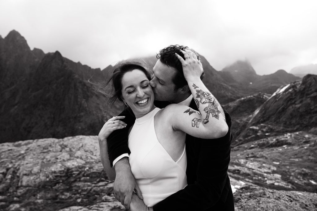 Bride on a mountain hike elopement in Lofoten,BW. By Christin Eide Photography