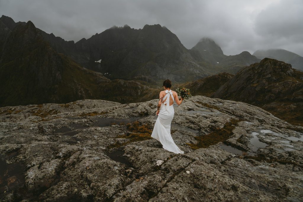 Bride on a mountain hike elopement. By Christin Eide Photography