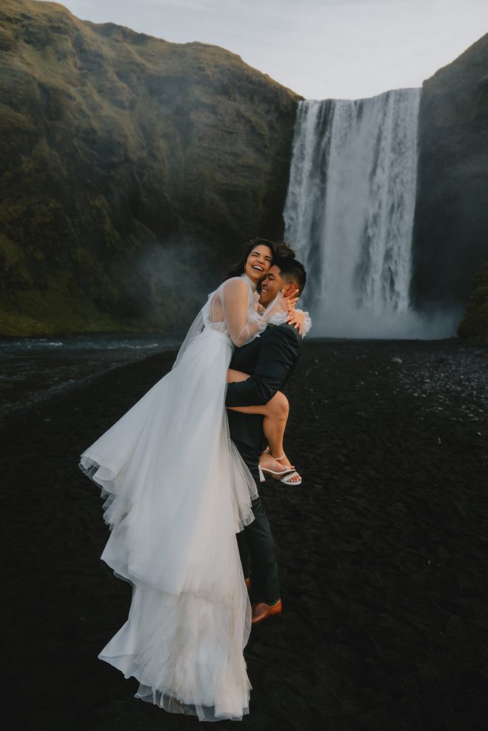 Being together under the magnificent Skogafoss in Iceland. By Christin Eide Photography