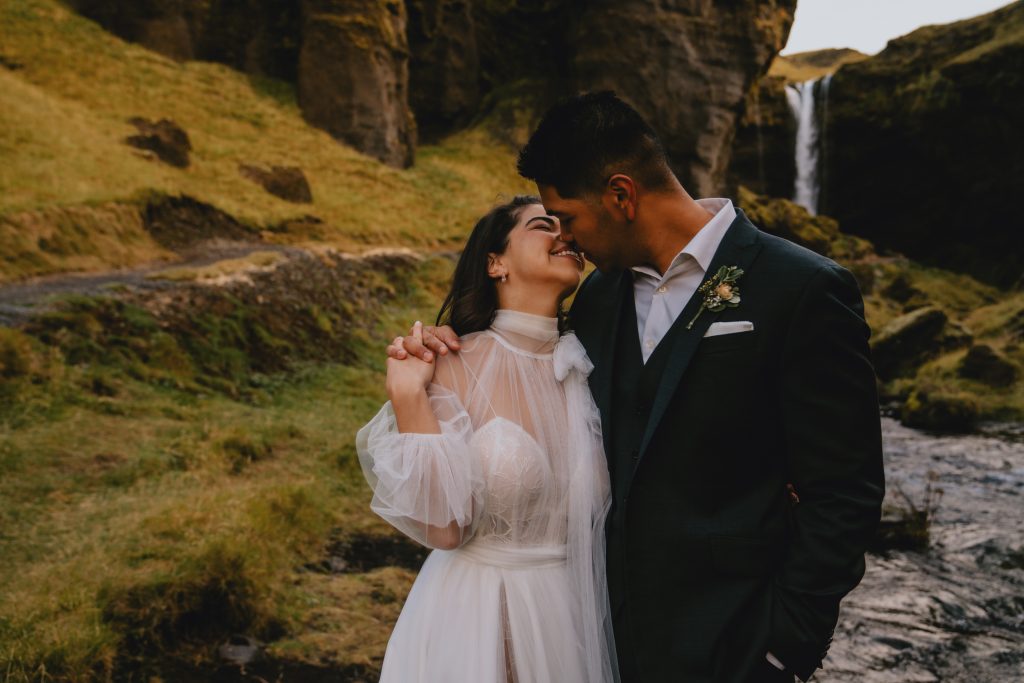 Intimate moment under waterfall canyon in Iceland. By Christin Eide Photography