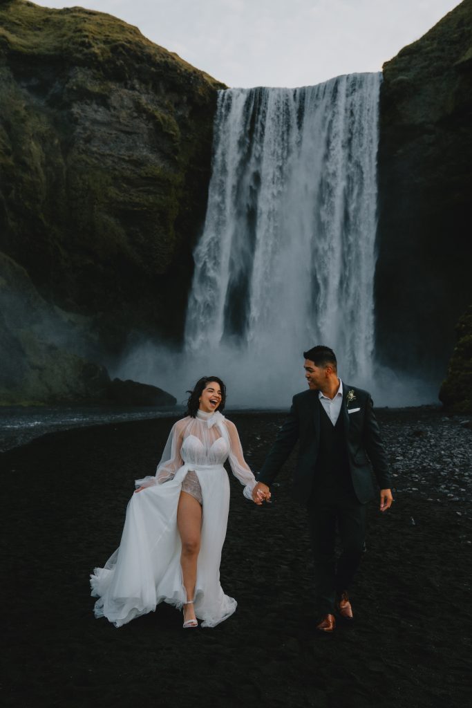 Enjoying a moment under the magnificent Skogafoss in Iceland. By Christin Eide Photography